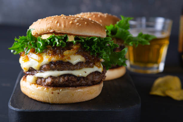 istock Big hamburger with cheese and green salad 1391936421