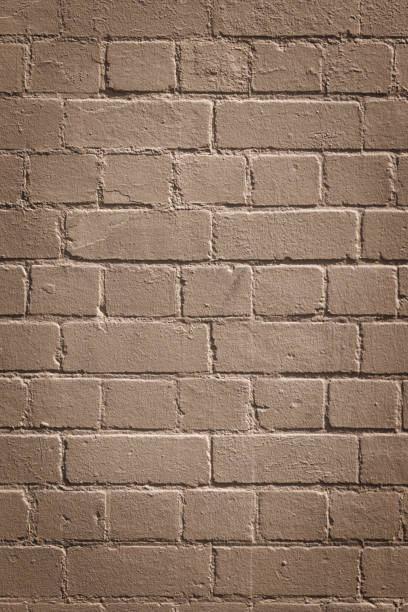istock Part of a painted old beige brick wall 1391937171