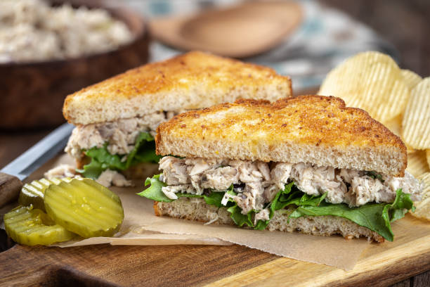 tuna salad sandwich cut in half - tuna imagens e fotografias de stock