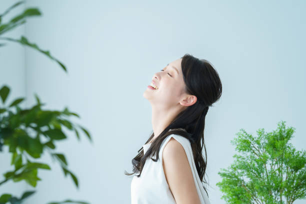 istock A woman taking a deep breath while bathing in the light 1391938731