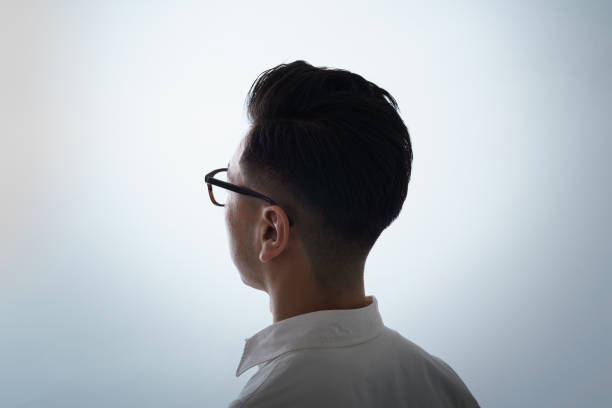 Asian man with a serious face wearing glasses