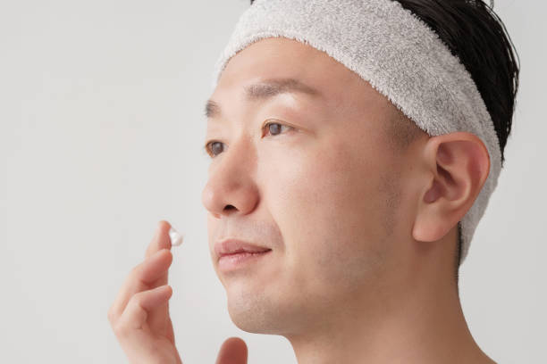 istock Middle man applying cream to his face 1391941581