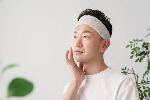 istock Middle man applying cream to his face 1391941600