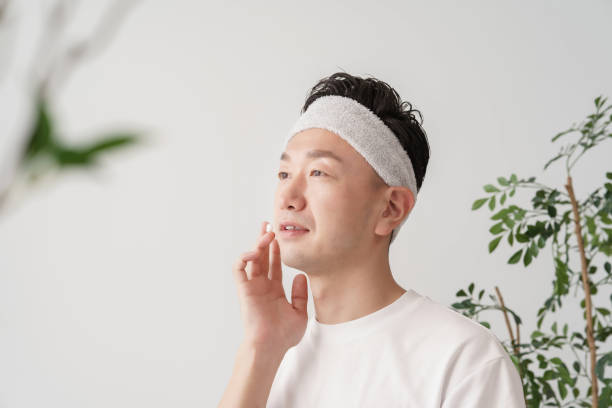 istock Middle man applying cream to his face 1391941624