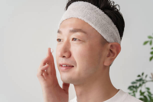 istock Middle man applying cream to his face 1391941643