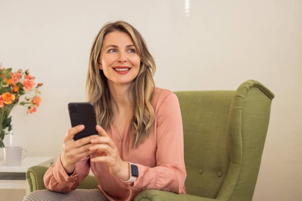 istock Woman at home using smart phone 1391942076