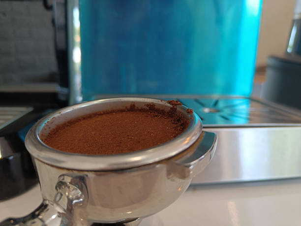istock Portafilter with coffee powder on white table 1391942688