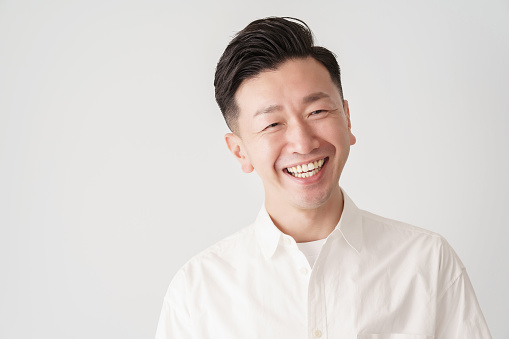 Asian LGBTQIA gay person looking at camera smiling