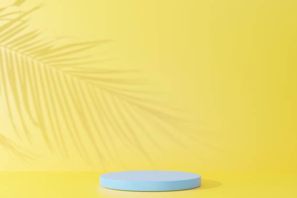 istock Blue podium and palm leaf shadow on yellow abstract background. 1391942997