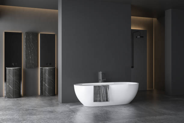 istock Dark grey bathroom with white bathtub and two sinks with square mirrors and shower area. 1391943024