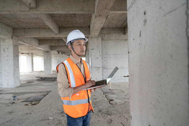 istock A male engineer works on a laptop at a construction site for a modern office building. 1391943969