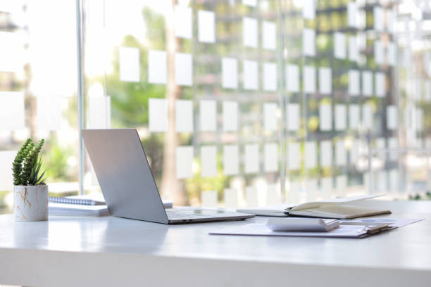 istock Laptop on a desk in an open financial office. 1391946152
