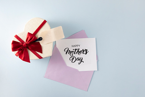 Happy Mother's Day gift tag with heart shaped gift box with envelope on blue background