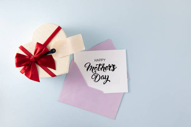 Heart Shaped Gift Box with Tag Happy Mother's Day gift tag with heart shaped gift box with envelope on blue background gift tag note stock pictures, royalty-free photos & images
