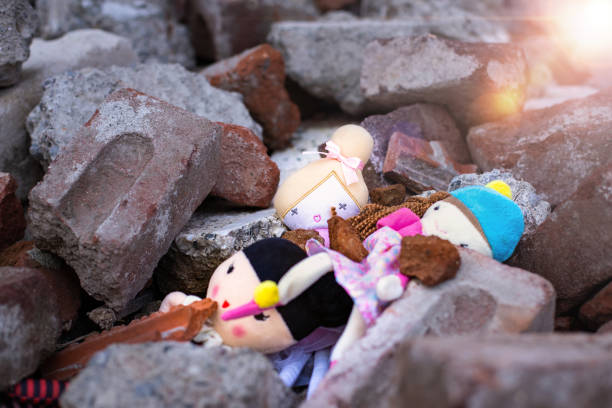 Toys on the rubble of a collapsed building Toys on the rubble of a collapsed building mariupol stock pictures, royalty-free photos & images