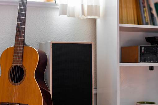Student bedroom with guitar, speak and books