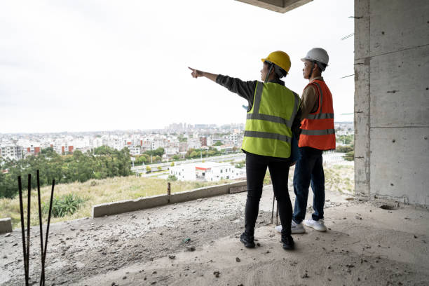 istock Two engineers were discussing their work at an office building construction site. 1391953077