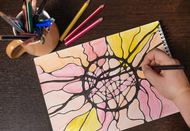 Neurographic drawing, relaxation for body and brain. Mental health of soul and body, neurolines, neural connections. Psychological technique, psychology. Black marker pen on a multicolored drawing.