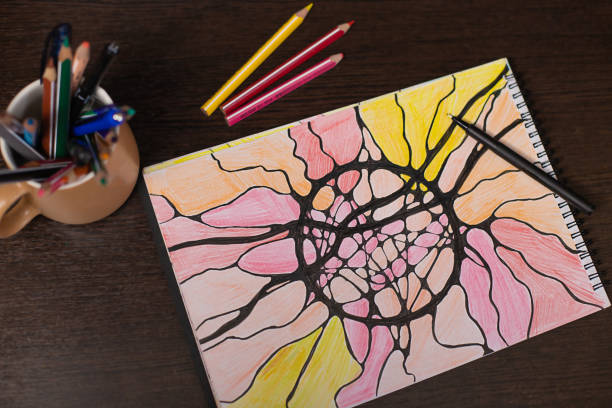 Neurographic drawing, relaxation for body and brain. Mental health of soul and body, neurolines, neural connections. psychological technique, psychology. Black marker pen on a multicolored drawing.