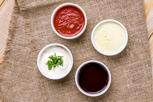 assorted sauces top view on wooden table