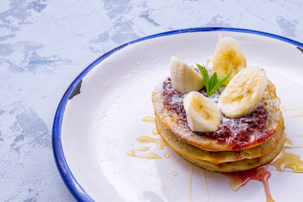 istock pancake with bananas and raspberry jam on plate 1391962124