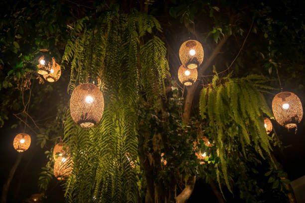 istock Decor hanging lantern with light bulbs on tree at night at park 1391962260