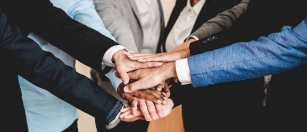istock Multicultural business people stacking hands with colleagues inside modern office - Focus on African man hands 1391968970