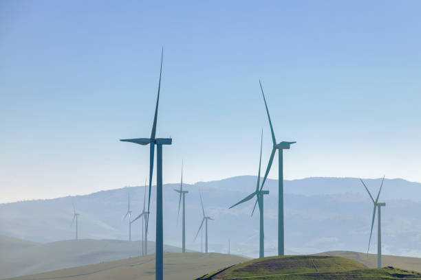 istock Electrical wind power mills over the blue sky. 1391969874