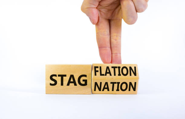istock Stagflation or stagnation symbol. Businessman turns cubes, changes the word stagnation to stagflation. Beautiful white table, white background, copy space. Business, stagflation or stagnation concept. 1391970083