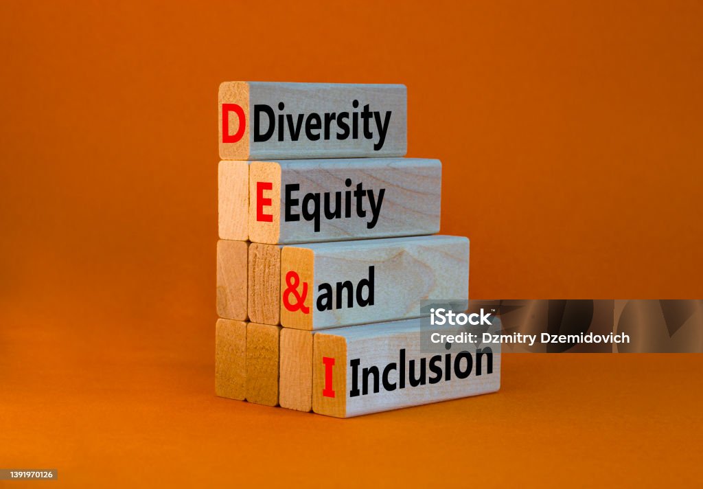 DEI, Diversity, equity and inclusion symbol. Concept words DEI, diversity, equity and inclusion on wooden blocks on beautiful orange background. Business, DEI, diversity, equity and inclusion concept. Social Inclusion Stock Photo