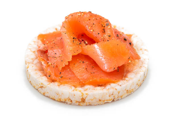 istock Rice Cake Sandwich with Fresh Salmon Slices Isolated on White 1391970158