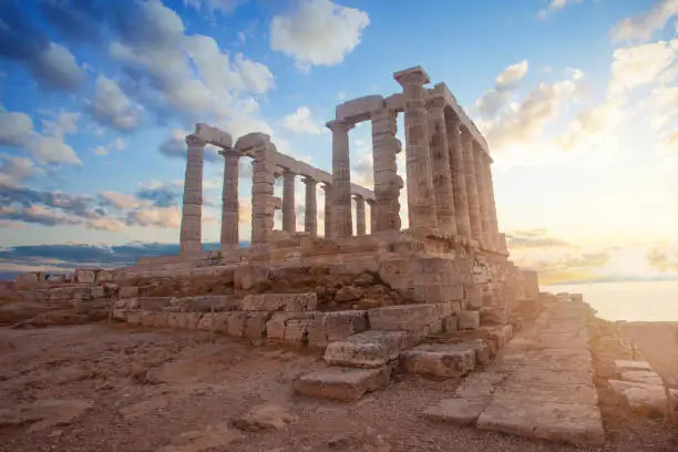 Greek temple ruins on sunset. Tourist landmark of Attica, Sounion, Greece