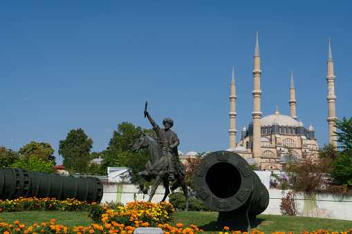 Edirne, Turkey - August 27, 2021: Selimiye Mosque built between 1569 and 1575 in Edirne, Turkey. Selimiye Mosque, designed by Mimar Sinan in 1575.Fatih Sultan Mehmet (Mehmed the Conqueror) statue with Selimiye Mosque on background in Edirne, Turkey