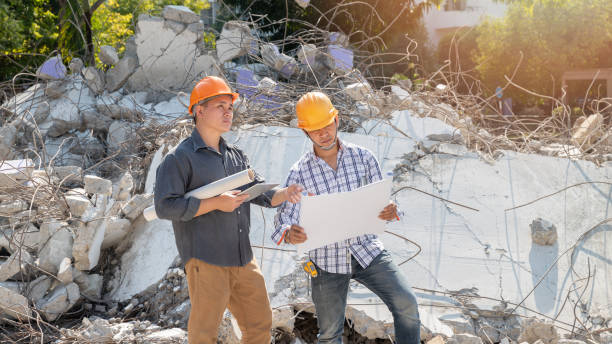 Demolition control supervisor and contractor discussing on demolish building. stock photo