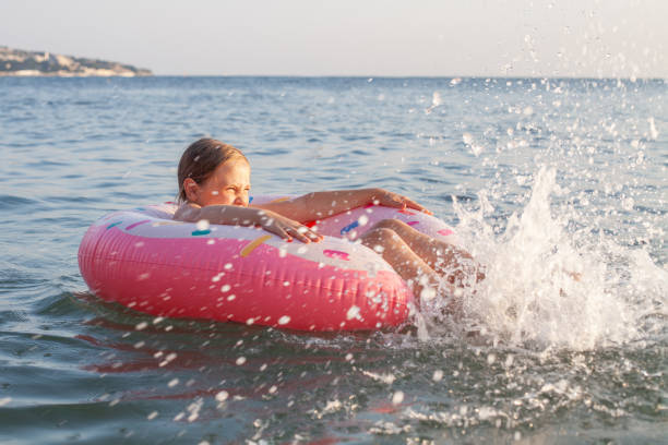 istock Happy child playing in the sea 1391971268