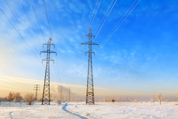 istock High voltage power lines at sunset. Winter landscape. 1391972269