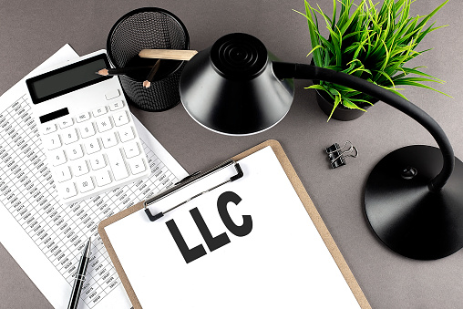 Clipboard ,chart and calculator, lamp and workspace accessories on a grey table. Top view , LLC