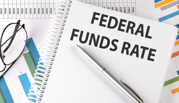 istock FEDERAL FUNDS RATE text , pen and glasses on the chart 1391972322