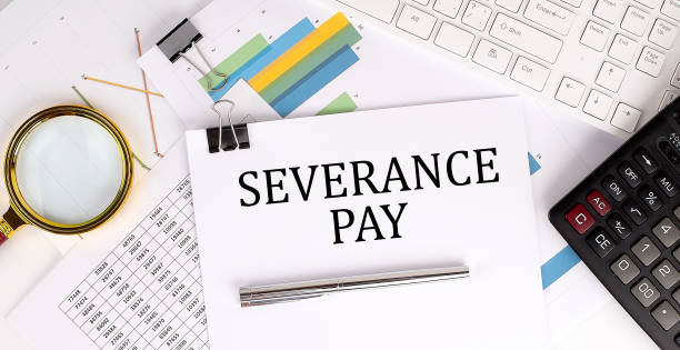 istock SEVERANCE PAY text on the white paper on the light background with charts paper ,keyboard and calculator 1391972325