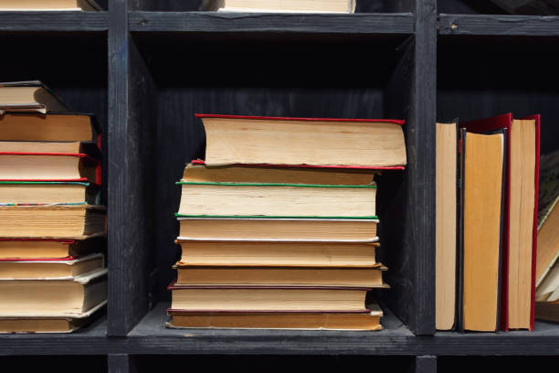 istock many books yellowed from time lie on a dusty shelf 1391972365