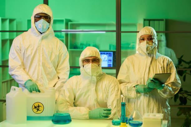 istock Group of young intercultural scientists or lab workers in protective coveralls 1391972367