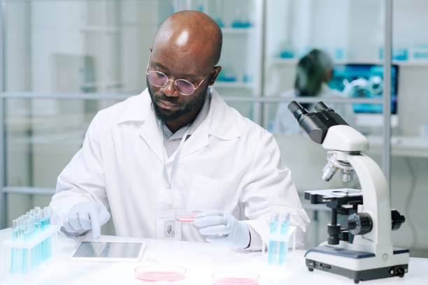 istock African American scientist scrolling in tablet while searching for online data 1391972393