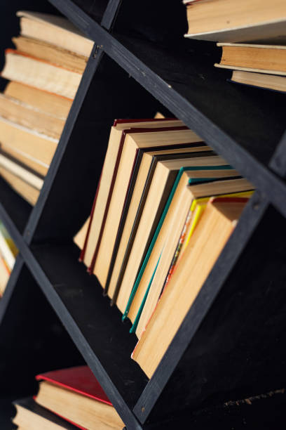 istock many books yellowed from time lie on a dusty shelf 1391972446