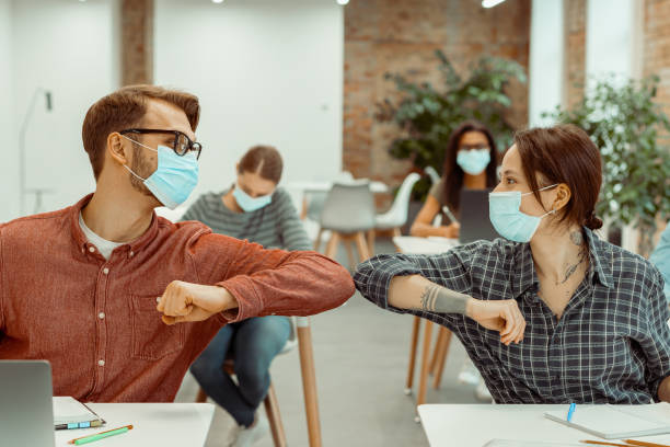 istock Two students bumping their elbows instead of greeting with a hug 1391972871