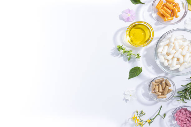 Flat lay composition of various vitamin capsules and dietary supplements isolated on white background with copy space.