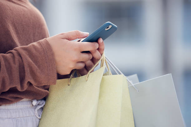 istock Shot of a woman using her smartphone to send a text while shopping 1391976976