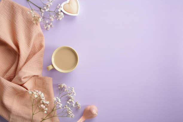 istock Stylish flat lay composition with morning coffee cup, beige plaid, heart shaped candle, decor and spring flowers on pastel purple background. Top view. 1391977090