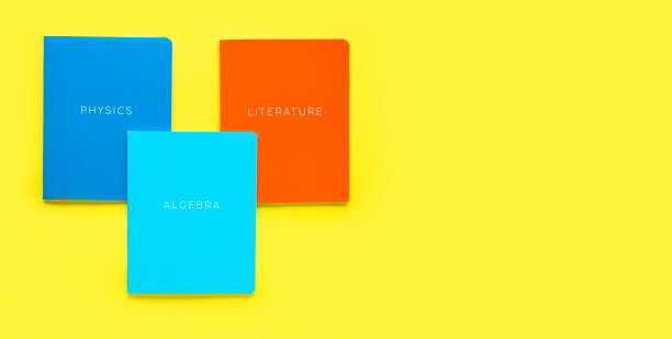 istock Multicolored exercise books on yellow background, close up. Education and reading concept - group of colorful textbooks. Flat Lay. Back to school. School science. Copy space 1391981162