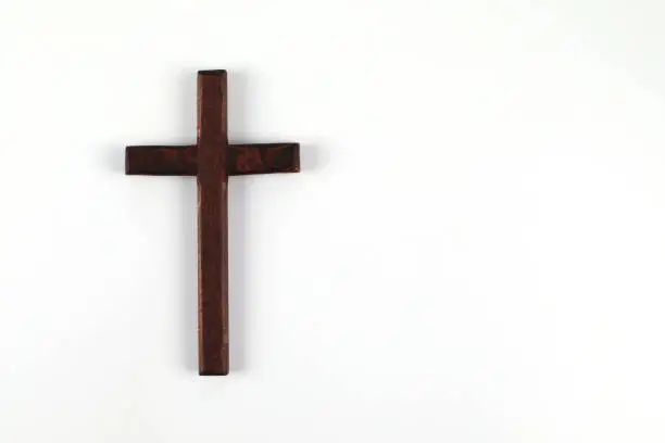 Photo of Wooden christian cross on white background with space to write.