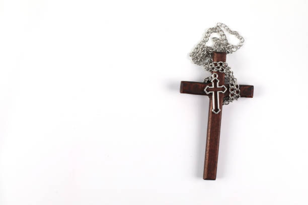 istock Wooden christian cross on white background with space to write. 1391982986